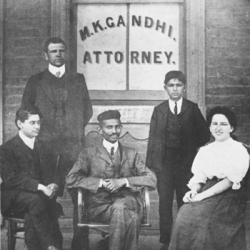 Mohandas Gandhi in center sits with coworkers at his Johannesburg law office